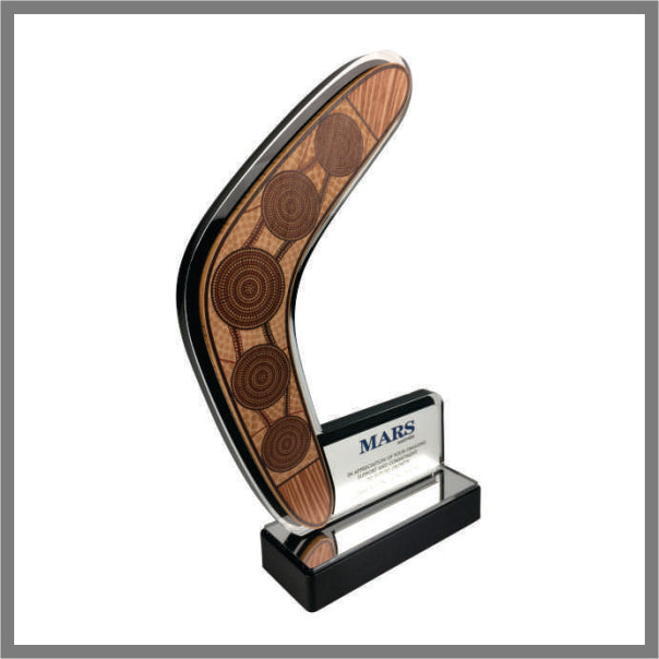 Custom boomerang-shaped Indigenous art award trophy with timber-look artwork, a personalised plaque and a glossy black base.